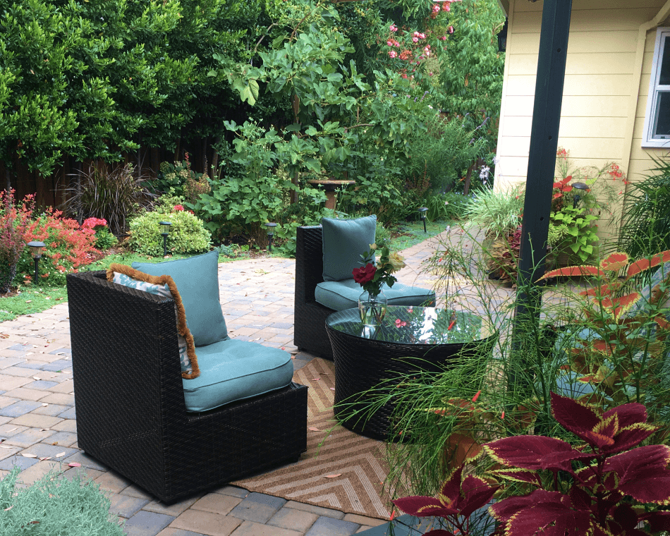 Edible gardens with fig and persimmon trees in an outdoor living and entertainment area with water features in Palo Alto.